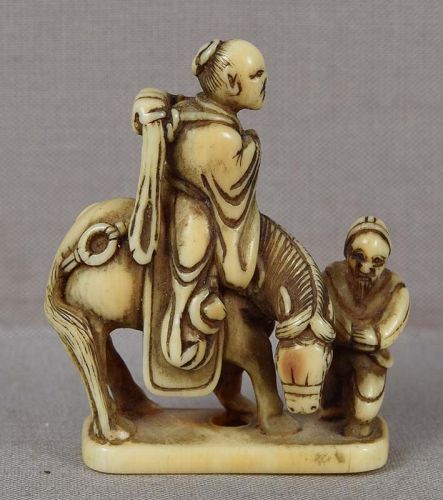 Early 19c netsuke TOBA on mule with attendant