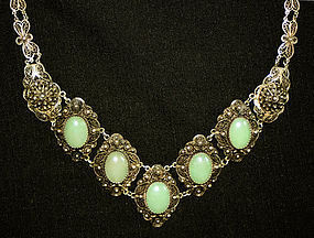 Ornate silver filigree necklace with stones