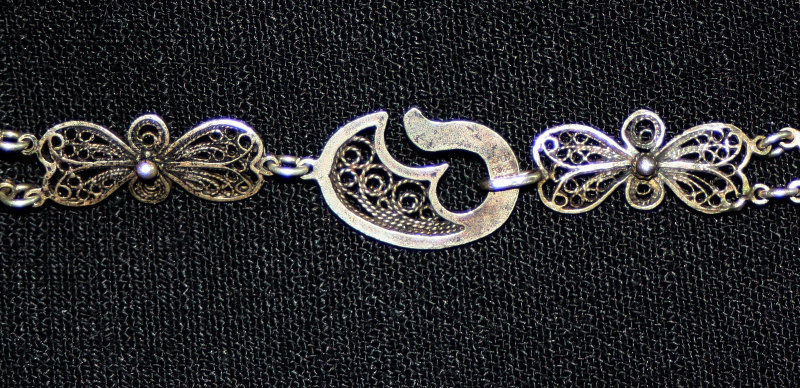 Ornate silver filigree necklace with stones