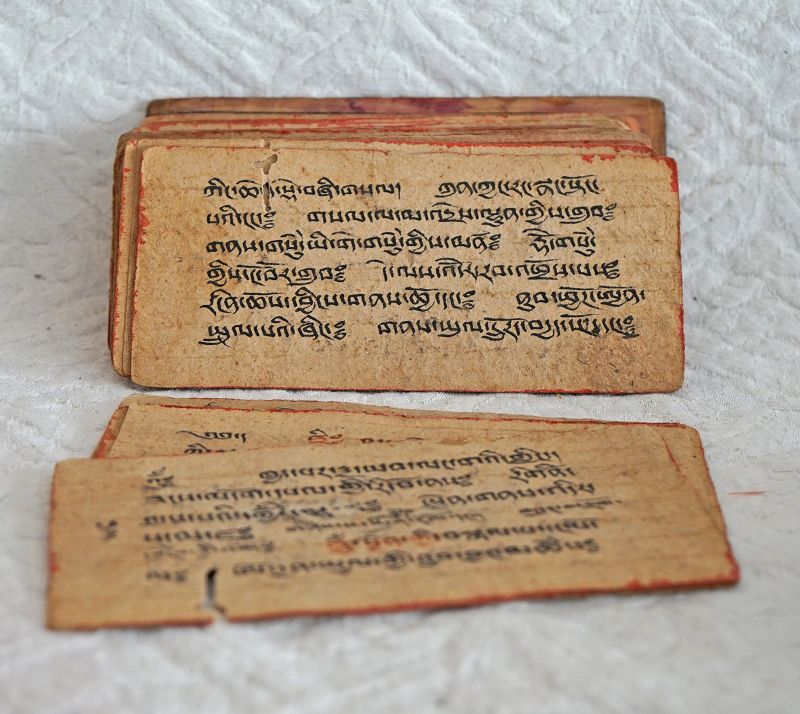 Small Tibetan sutra book with original covers and strap