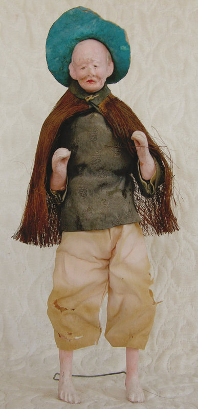 Antique Chinese farmer doll with raincoat