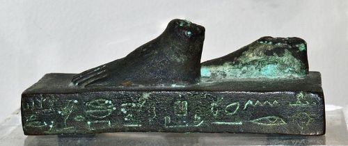 AN ANCIENT EGYPTIAN BRONZE BASE STATUE OF A STRIDING FIGURE