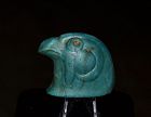 AN ANCIENT EGYPTIAN GLASS INLAY OF A FALCON HEAD