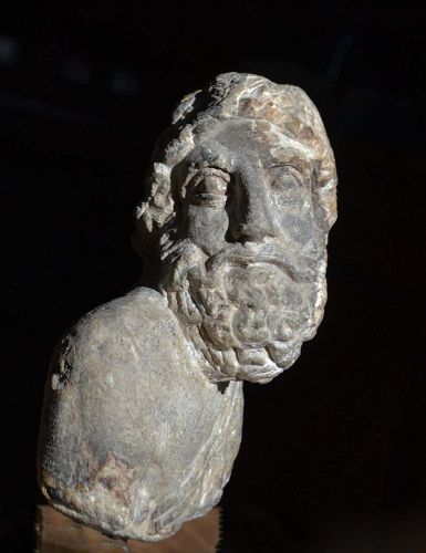 A ROMAN LIMESTONE BUST OF HERAKLES