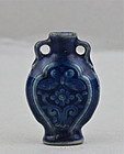 A BLUE GLAZED SNUFF BOTTLE WITH INCISED BUTTERFLY AND CHRYSANTHEMUM