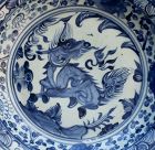 A MING DYNASTY BLUE AND WHITE DISH WITH QIRIN
