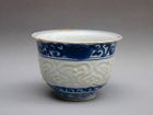 A LATE MING DYNASTY 17th CENTURY B/W CUP WITH INCISED DESIGN