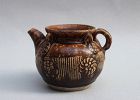 A BROWN GLAZE EWER WITH MOLDED INCISED CHRYSANTHEMUM