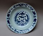 A LATE MING DYNASTY BLUE AND WHITE DISH WITH BIRD AND DUCKS