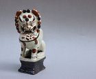 A MING DYNASTY CIZHOU WARE FIGURINE OF LION CANDLE HOLDER