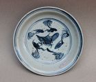 A MING DYNASTY BLUE AND WHITE DISH WITH FISH
