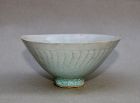 A SONG/YUAN DYNASTY QINGBAI CONICAL BOWL WITH INCISED INFANTS