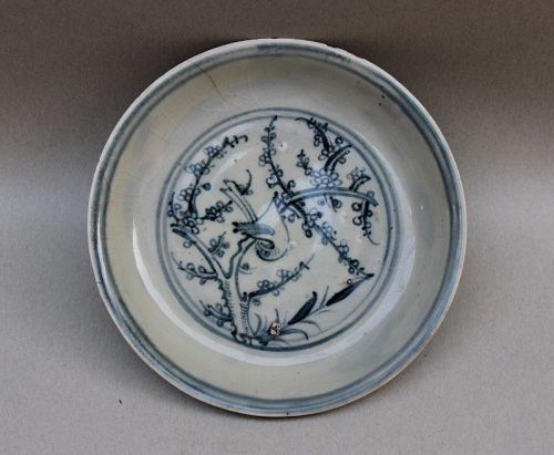 A BLUE AND WHITE DISH OF MING DYNASTY WITH A BIRD ON THE TREE