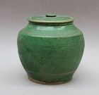 A SONG DYNASTY GREEN GLAZED JAR AND ORIGINAL COVER