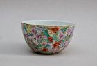 A FINE QING DYNASTY FAMILLE ROSE MILLE FLEURS ROUNDED SIDE CUP