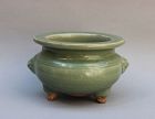 A MING DYNASTY LONGQUAN CELADON TRIPOD CENSER WITH LION MASK