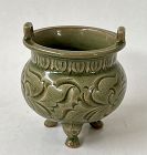 A RARE CELADON TRIPOD CENSER WITH CARVED INCISED FLOWER SPRAY