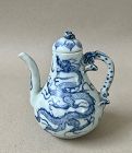 A LATE YUAN DYNASTY BLUE AND WHITE EWER WITH DRAGONS