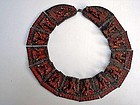 A copper and red coral Buddha statue chain