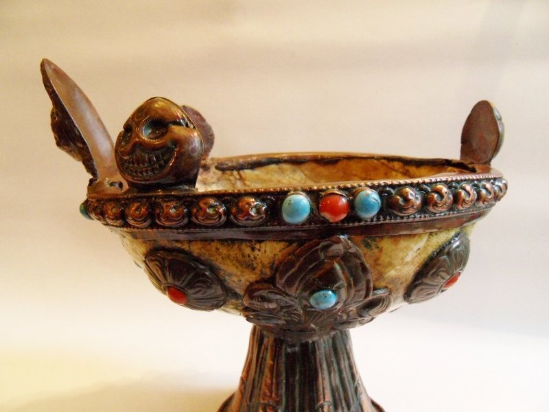 Tibetan skull cup or kapala on a purple copper stand