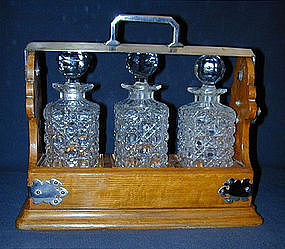 A Victorian Oak and Silverplate Tantalus