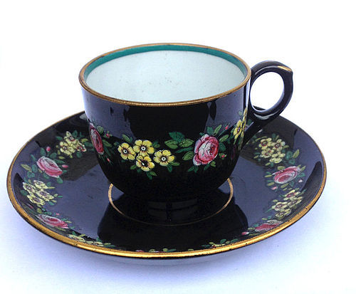 Jackfield black glazed and enamelled cup and saucer, Victorian