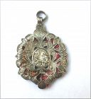 Silver reliquary pendant: St Anthony of Padua, with textile fragment