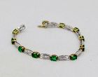 Colombian emerald and diamond tennis link bracelet in 18k gold