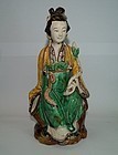 Late Ming dynasty sancai glaze figure of seated lady.