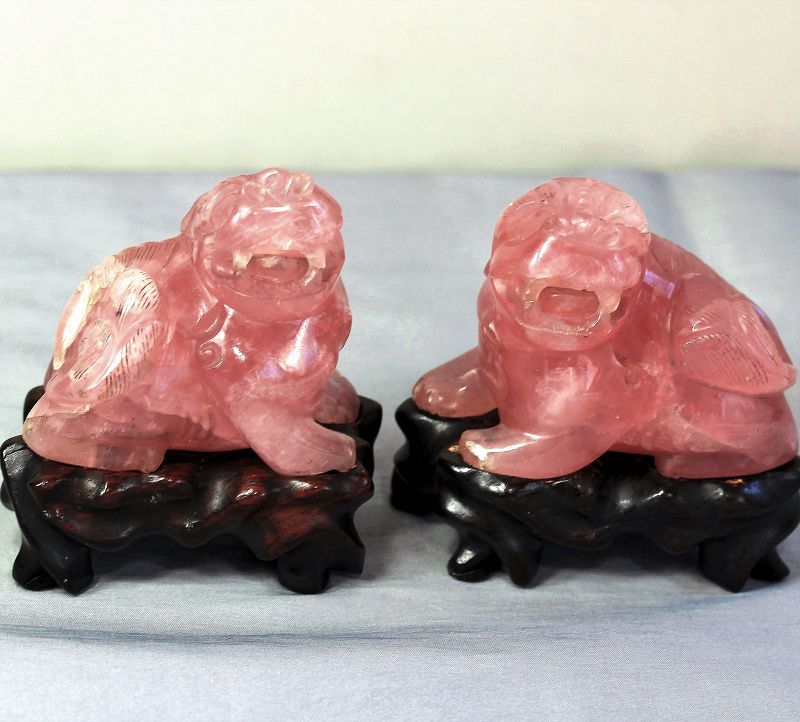 Pair Chinese Rose Quartz Foo Lions on hardwood stands