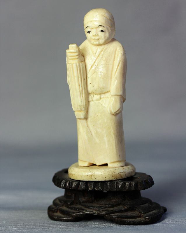 Japanese carved Bone Okimono, figure on wooden stand