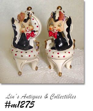 VINTAGE PAIR OF SKUNK FIGURINES SITTING ON CHAIRS