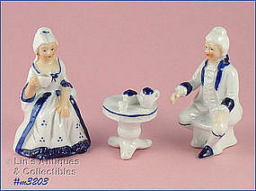 THREE PIECE COLONIAL FIGURINE SET