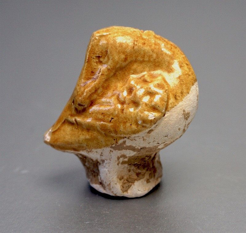 A Tang Dynasty Amber Glazed Pottery Figure of a Sleeping Duck