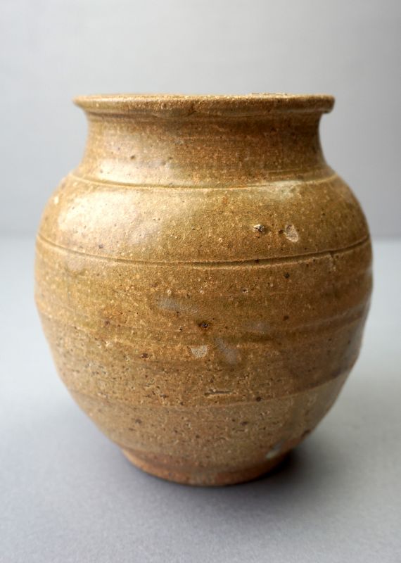 A Tang Dynasty Yue Yao Stoneware Jar with an Olive Green Glaze.