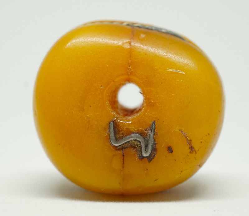 A Large Antique Amber Bead from the Sahara, with Silver Repairs