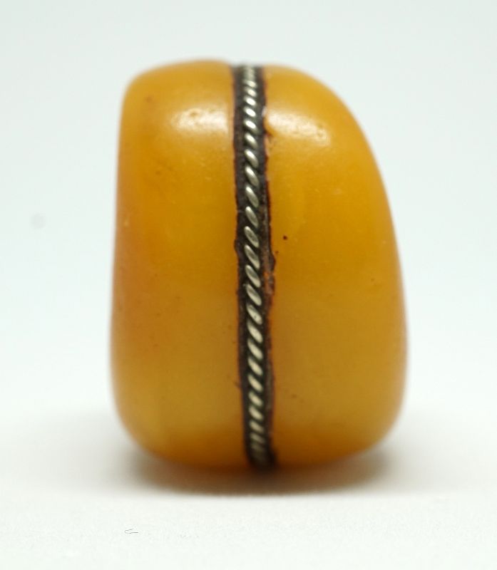 A Large Antique Amber Bead from the Sahara, with Silver Repairs