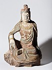 A Chinese wood carving of a seated Guanyin