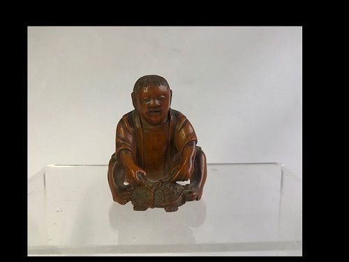 Japanese Wooden Netsuke of a Man Tying a Turtle