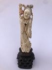 Chinese Carved Polychromed Depiction of Guanyin Holding Flowers