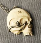 Japanese skull and snake pendant, signed