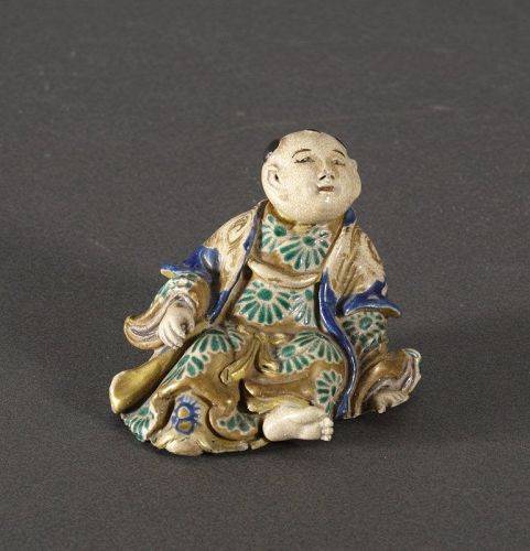 A Kyoyaki model of a seated man, 19th century.