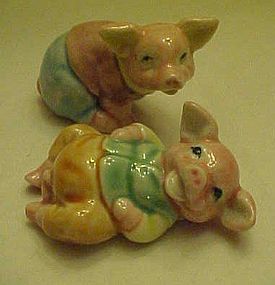 Porcelain pig figurines wearing pants and shirt