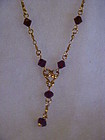 Avon Goldtone drop necklace with ruby crystal beads