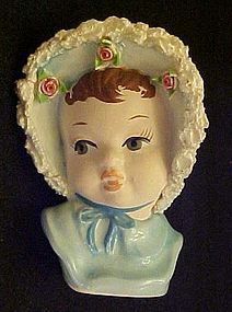 Baby girl in blue bonnet small head vase spaghetti trim