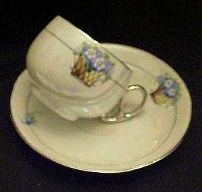 D&B Germany lustreware cup and saucer, flower basket