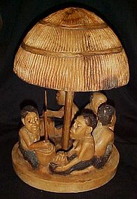 Hand carved Zimbabwe tribe and hut figure. Signed