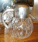 Heavy cut glass crystal water pitcher with silver plate