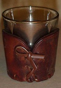 Three shot glasses with leather cozy's or jackets