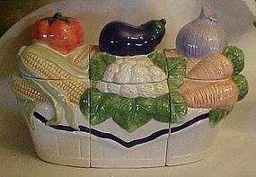 Three piece ceramic canister set with fresh vegetables